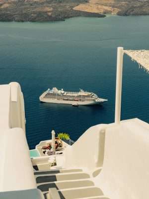 cruise ship near shore of coastal town